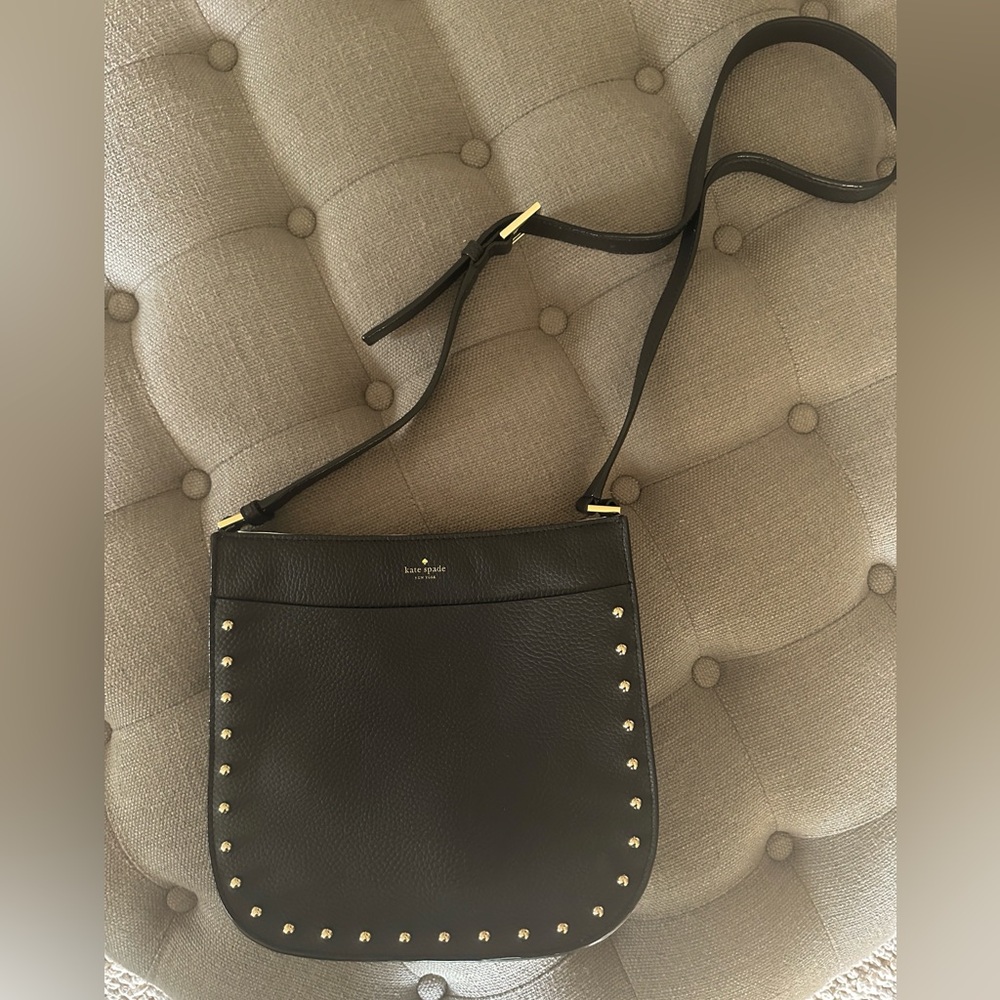 Kate Spade crossbody saddle bag in black with gold studs and detailing